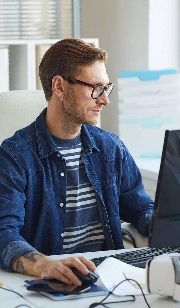 Office professional working on a desktop computer at a workstation